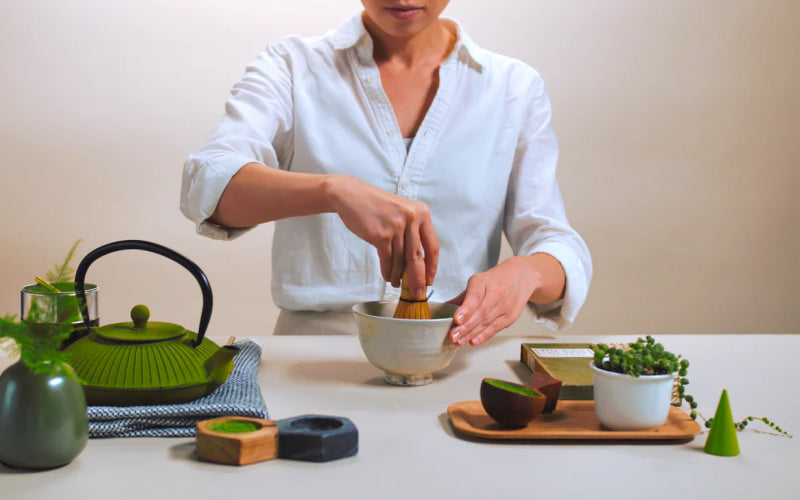 Woman whisking matcha