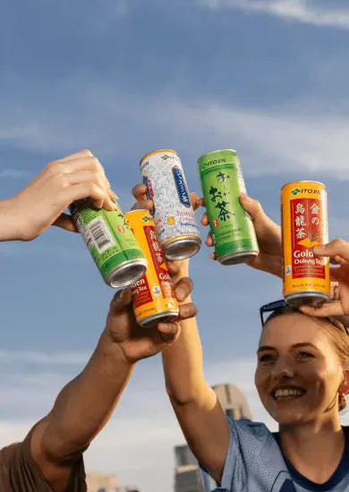 Hands Cheering with cans of Ito En Teas 1