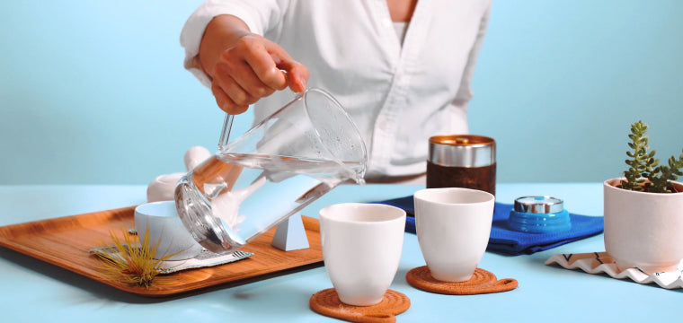 Pour boiled water in cups, which will cool the water to the ideal temperature.