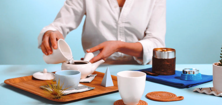 Pour water from the cups to the teapot.